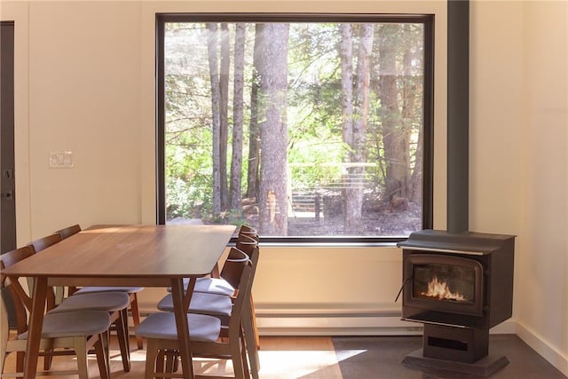 dining area with a healthy amount of sunlight and a wood stove