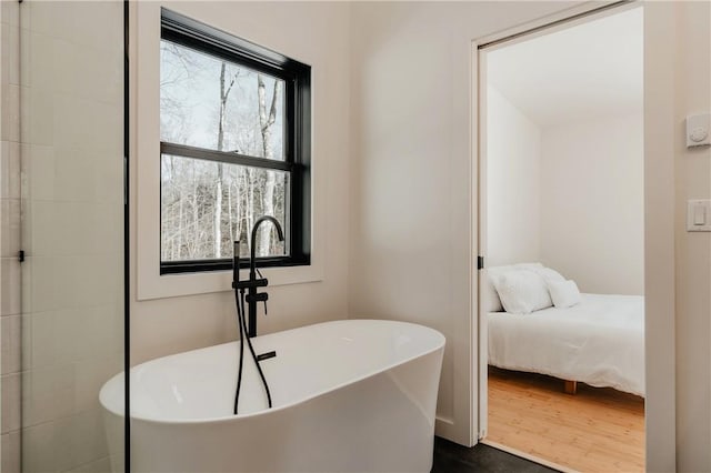 bathroom featuring a bath and wood-type flooring