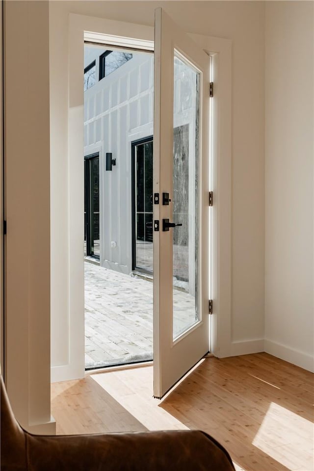 doorway to outside with french doors and wood-type flooring