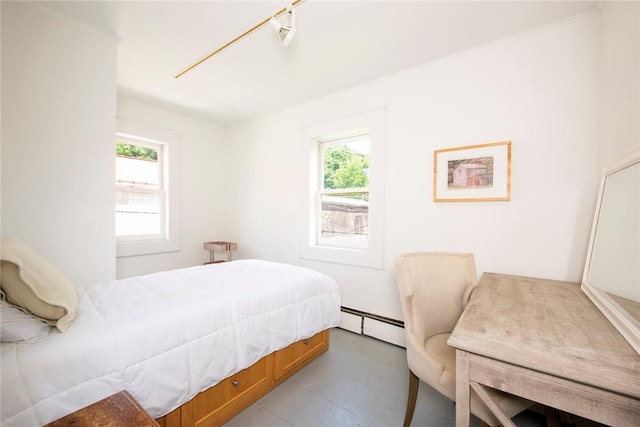 bedroom with multiple windows and a baseboard radiator