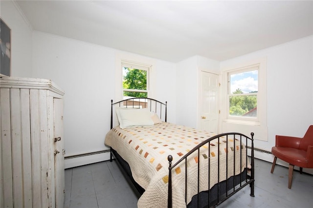 bedroom with baseboard heating, multiple windows, crown molding, and a closet