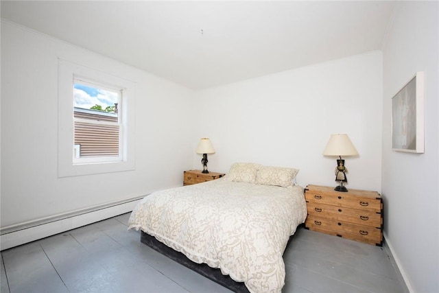 bedroom featuring ornamental molding and a baseboard heating unit