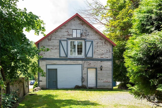 rear view of house featuring a yard