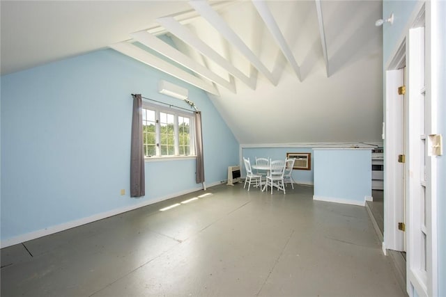 bonus room with lofted ceiling, concrete flooring, and an AC wall unit