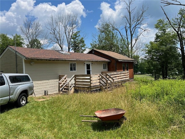 rear view of house featuring a deck