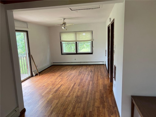 empty room with baseboard heating, dark wood-type flooring, and ceiling fan