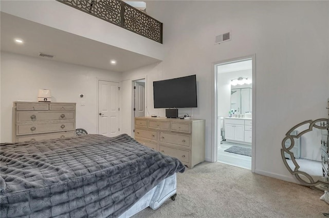 carpeted bedroom with ensuite bath