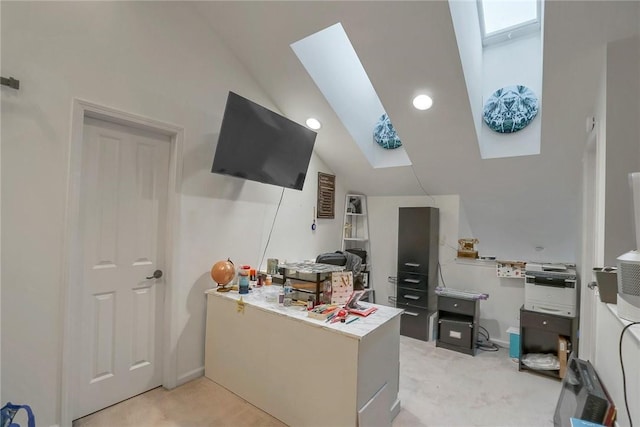 kitchen with light colored carpet and lofted ceiling with skylight