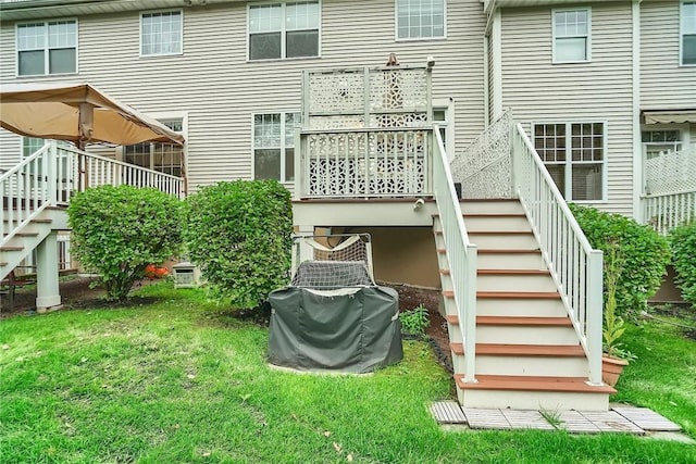 rear view of property featuring a lawn