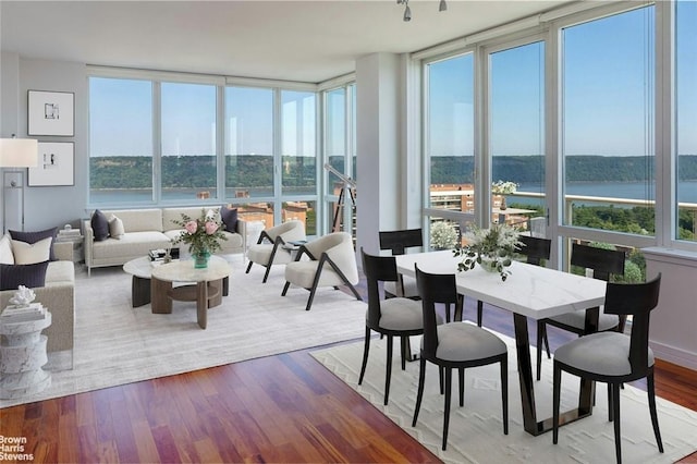 sunroom / solarium with a water view