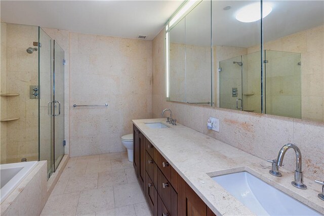 full bathroom featuring toilet, tile walls, independent shower and bath, and tasteful backsplash