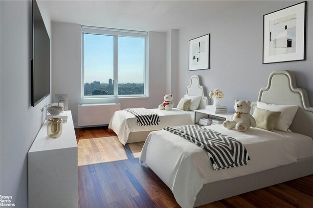 bedroom featuring radiator heating unit and dark wood-type flooring