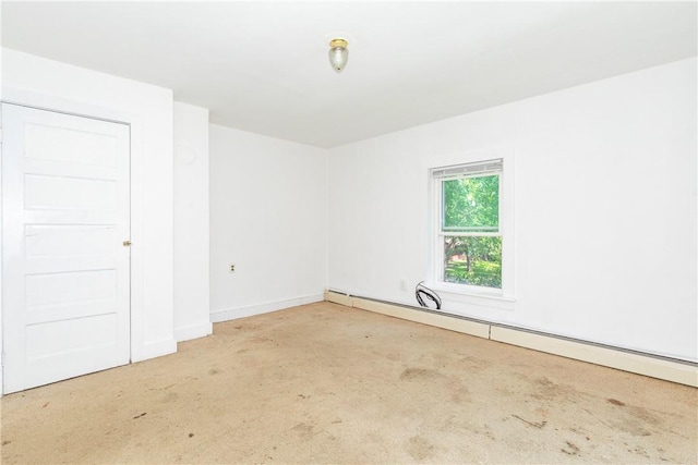 carpeted spare room with baseboard heating