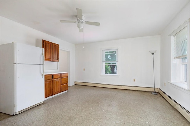 kitchen featuring white refrigerator, ceiling fan, and a baseboard heating unit