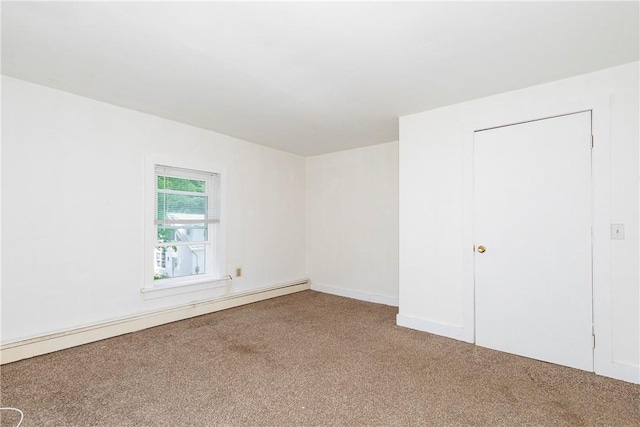 spare room featuring baseboard heating and carpet floors