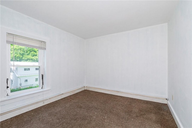 carpeted spare room with a baseboard radiator