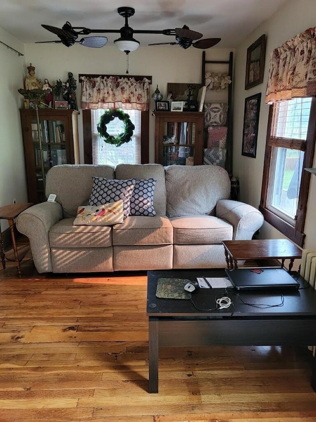 living room with hardwood / wood-style flooring and ceiling fan