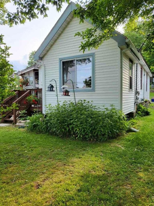 view of home's exterior with a lawn