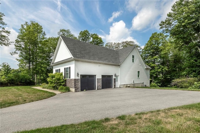 view of home's exterior with a lawn and a garage