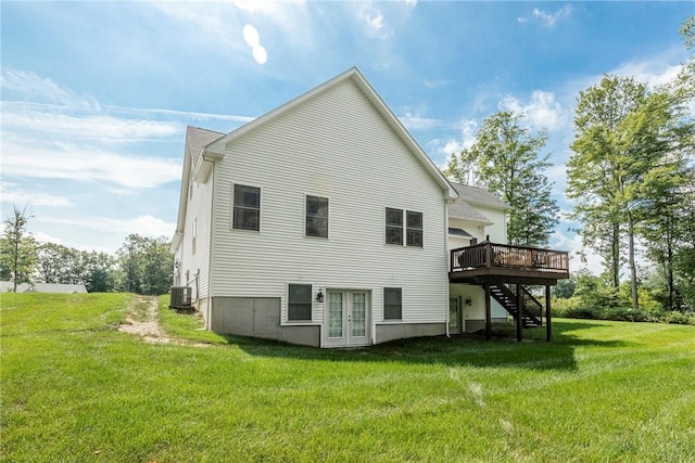 rear view of property with a lawn, central AC, a deck, and french doors