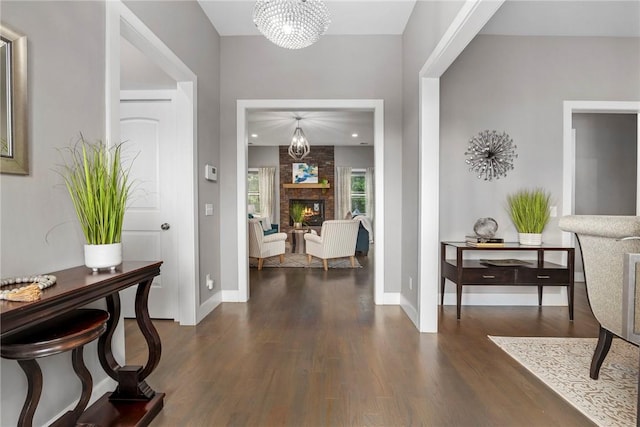 entrance foyer with a fireplace and dark wood-type flooring