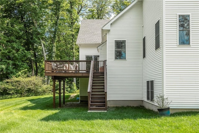 rear view of house with a yard and a deck