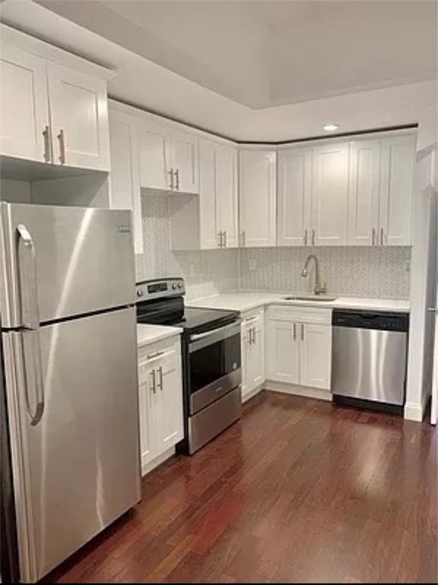 kitchen featuring dark hardwood / wood-style floors, sink, white cabinetry, and stainless steel appliances