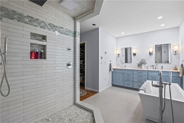 bathroom with vanity and shower with separate bathtub