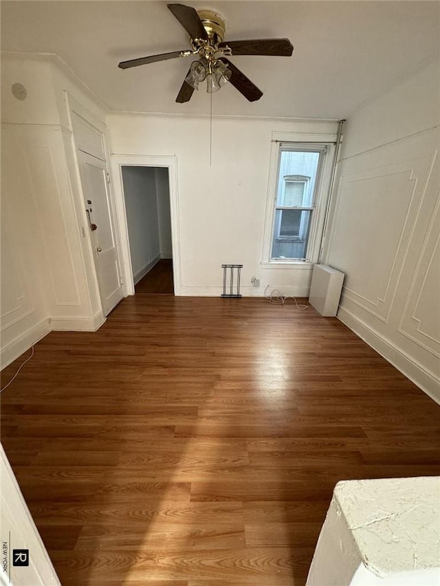 spare room with ceiling fan and dark wood-type flooring