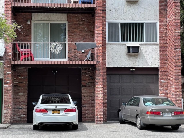 view of front of home with a balcony and a garage