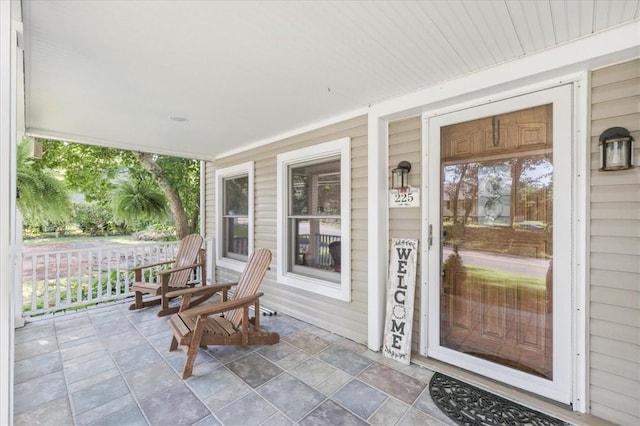 view of exterior entry with a porch