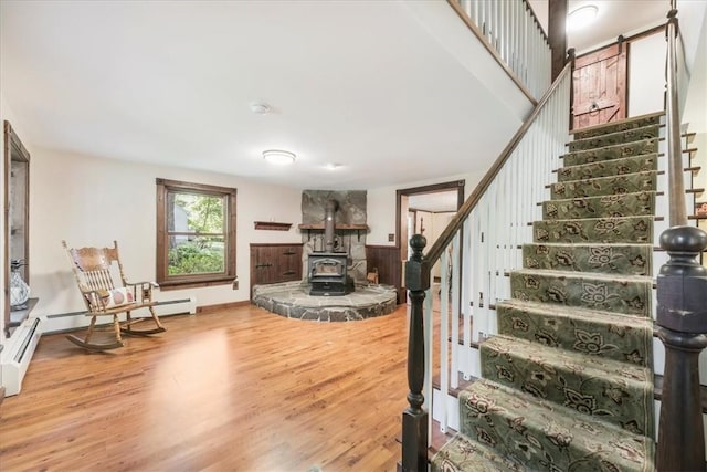 interior space featuring wood-type flooring and a wood stove