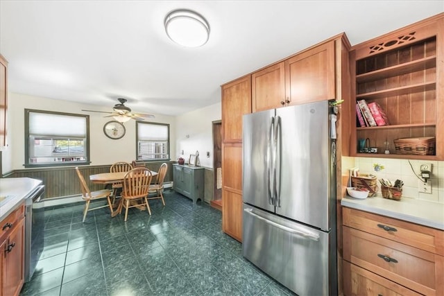 kitchen featuring decorative backsplash, ceiling fan, and stainless steel appliances