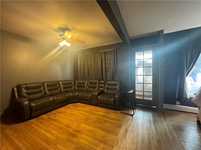 unfurnished living room with ceiling fan and wood-type flooring