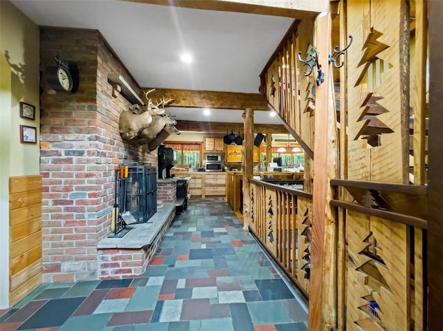 wine cellar featuring wooden walls and a brick fireplace