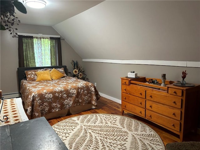 bedroom featuring baseboard heating, dark wood-type flooring, and vaulted ceiling