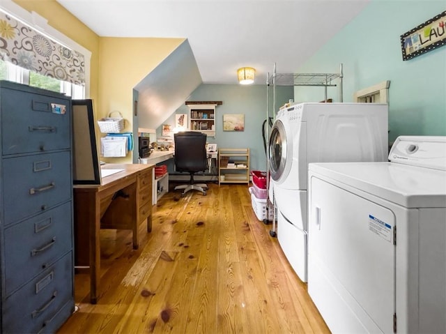 laundry area with washer and dryer and light hardwood / wood-style floors