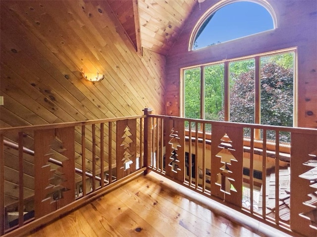 additional living space featuring wood ceiling, wooden walls, wood-type flooring, and lofted ceiling