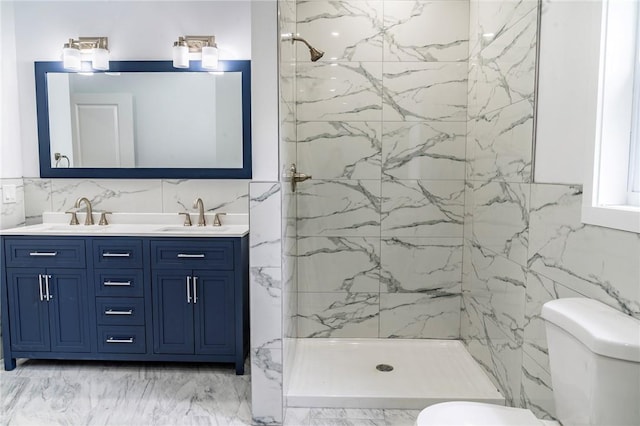 bathroom with a tile shower, vanity, tile walls, and toilet