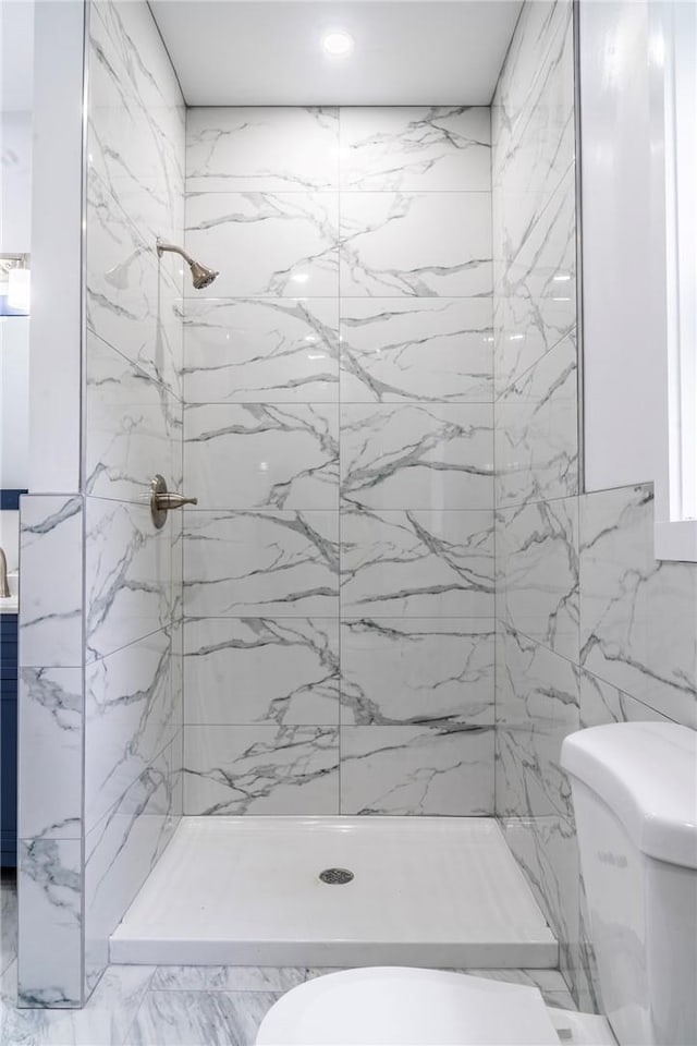 bathroom featuring toilet, tile walls, and tiled shower