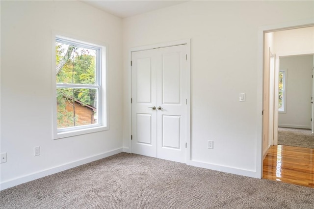 unfurnished bedroom featuring carpet flooring and a closet