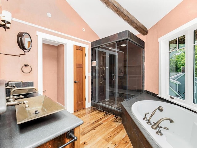 bathroom featuring hardwood / wood-style flooring, vaulted ceiling with beams, vanity, and independent shower and bath