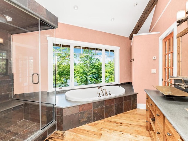 bathroom featuring lofted ceiling, vanity, hardwood / wood-style flooring, and independent shower and bath