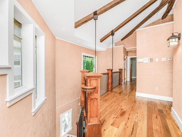 hall with beamed ceiling, light hardwood / wood-style floors, and high vaulted ceiling