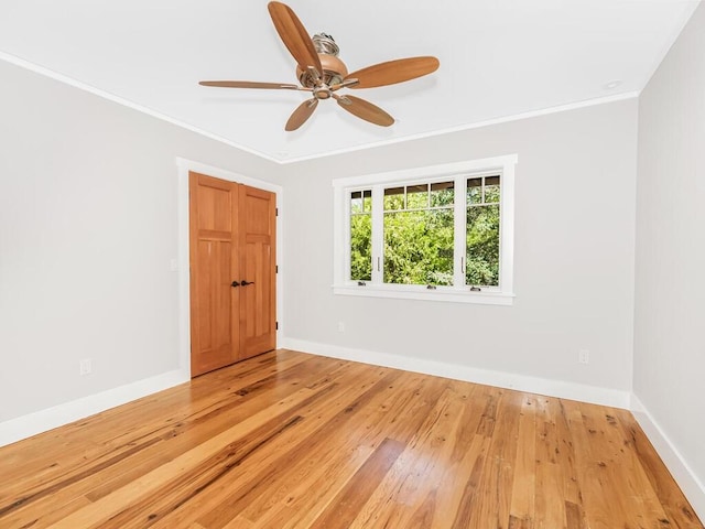 unfurnished room featuring wood-type flooring, ceiling fan, and crown molding