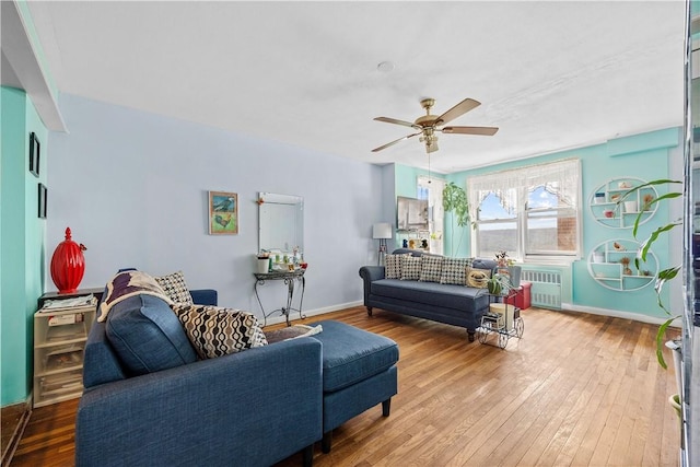 living room featuring hardwood / wood-style flooring, radiator, and ceiling fan