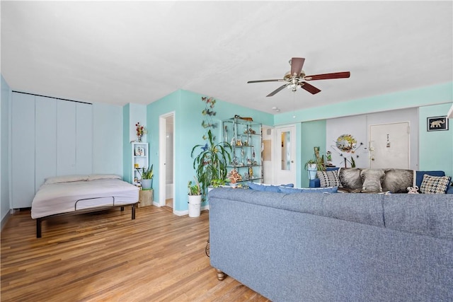 living room featuring wood-type flooring and ceiling fan