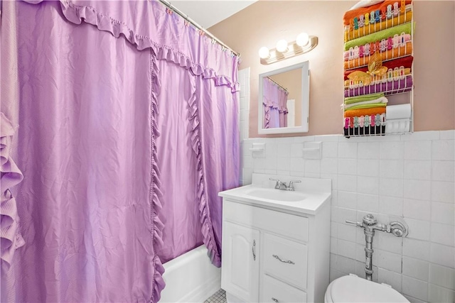 full bathroom featuring shower / tub combo with curtain, vanity, tile walls, and toilet