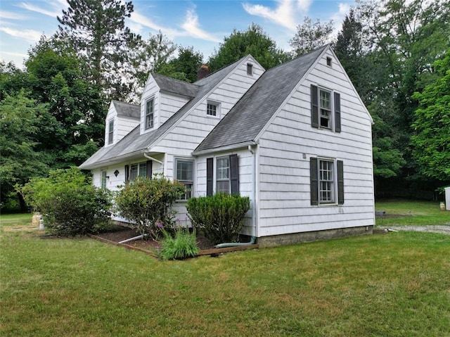 view of side of home with a lawn