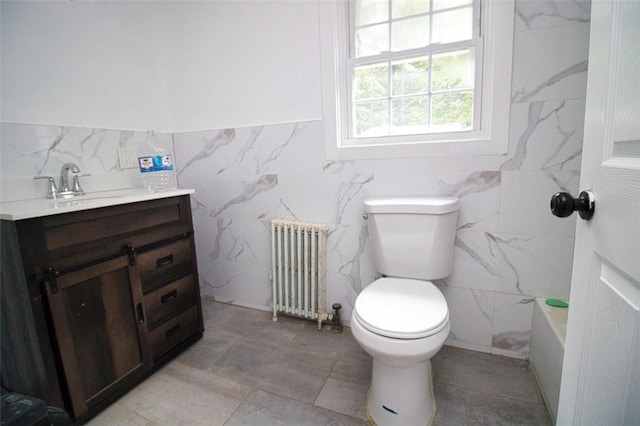 bathroom featuring vanity, a bath, toilet, tile walls, and radiator heating unit